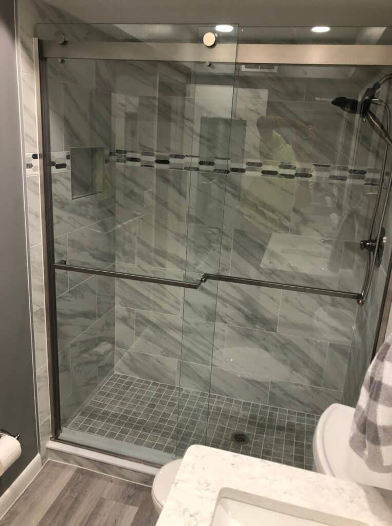Completed glass shower in a former tub footprint for conversion planning