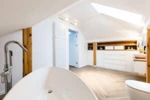 White modern bathroom interior on the attic with washbasin and window