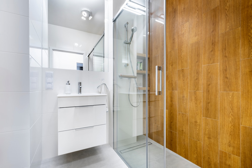 Modern bathroom interior design in white with wooden finishing