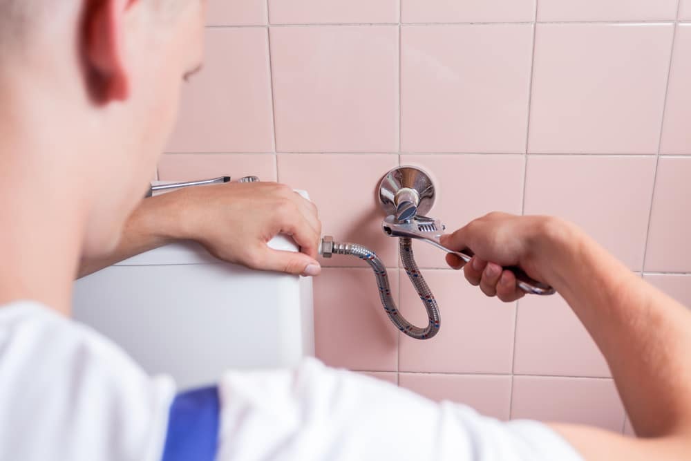 Handyman repairing a pipe with a wrench