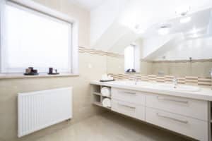 Two-person bathroom remodel with double vanity and bright finishes