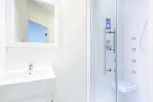 Low-threshold walk-in shower with glass door in a residential bathroom
