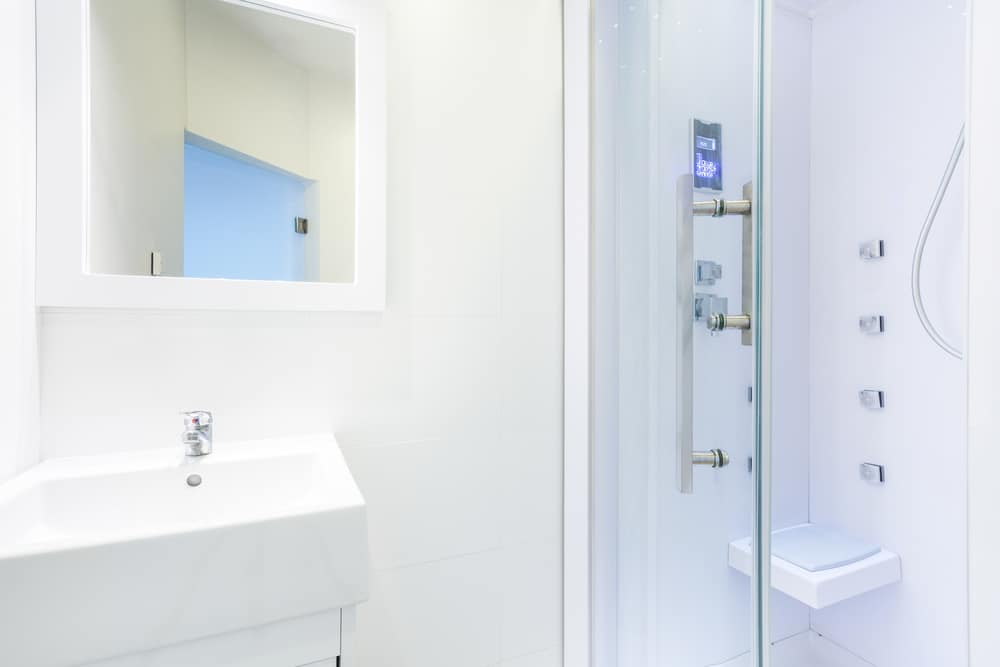 Low-threshold walk-in shower with glass door in a residential bathroom