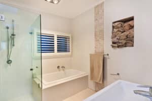 Stylish clean bathroom with shower and bath tub