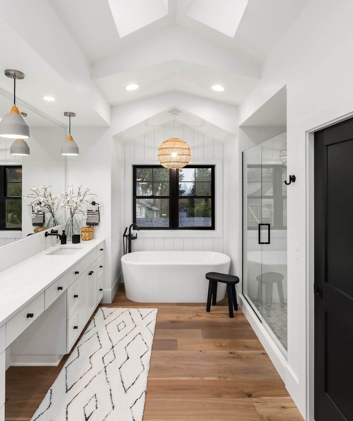 Bright master bathroom with vaulted ceiling and glass shower