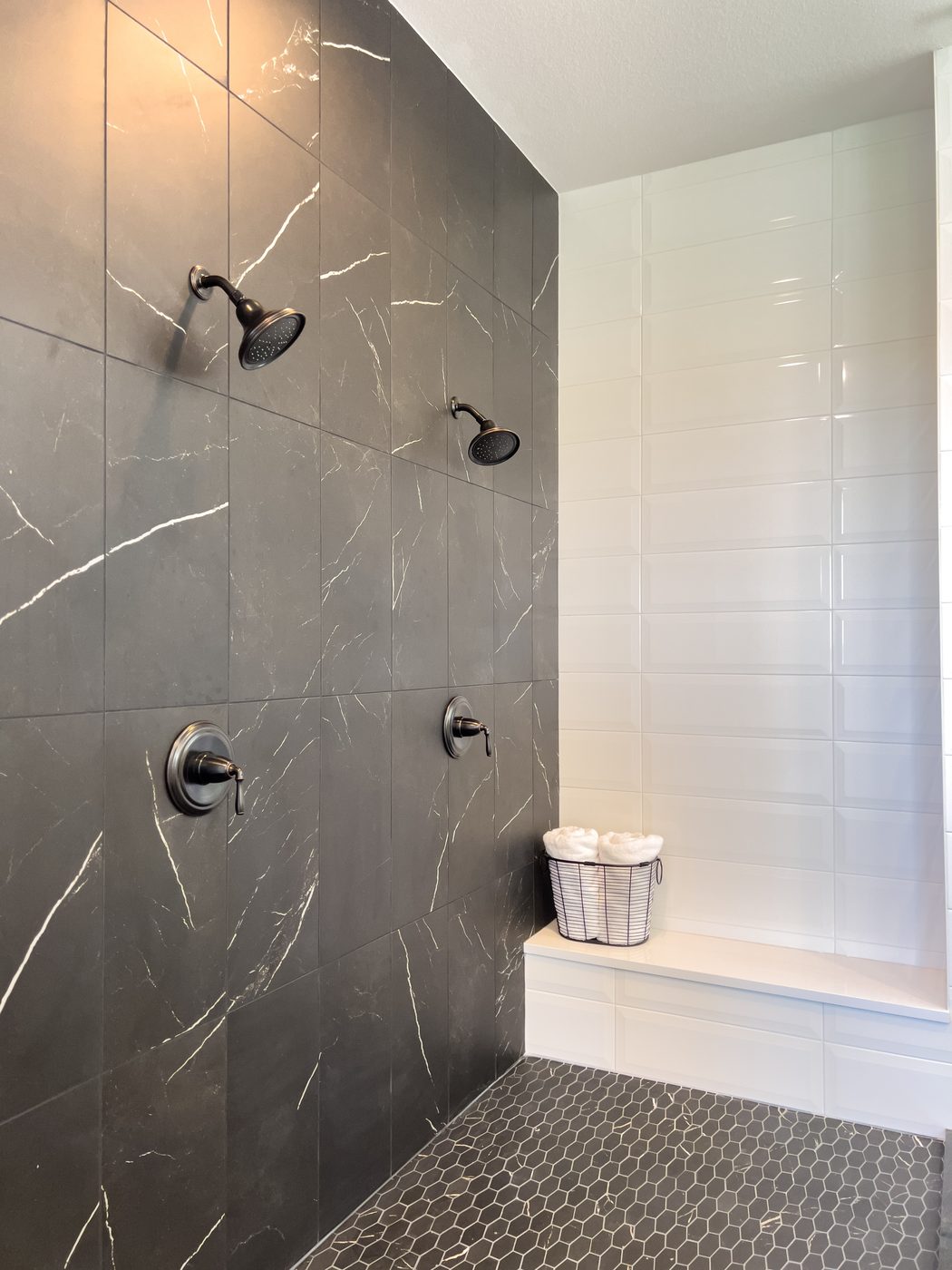 Gray marble walk-in shower with built-in bench