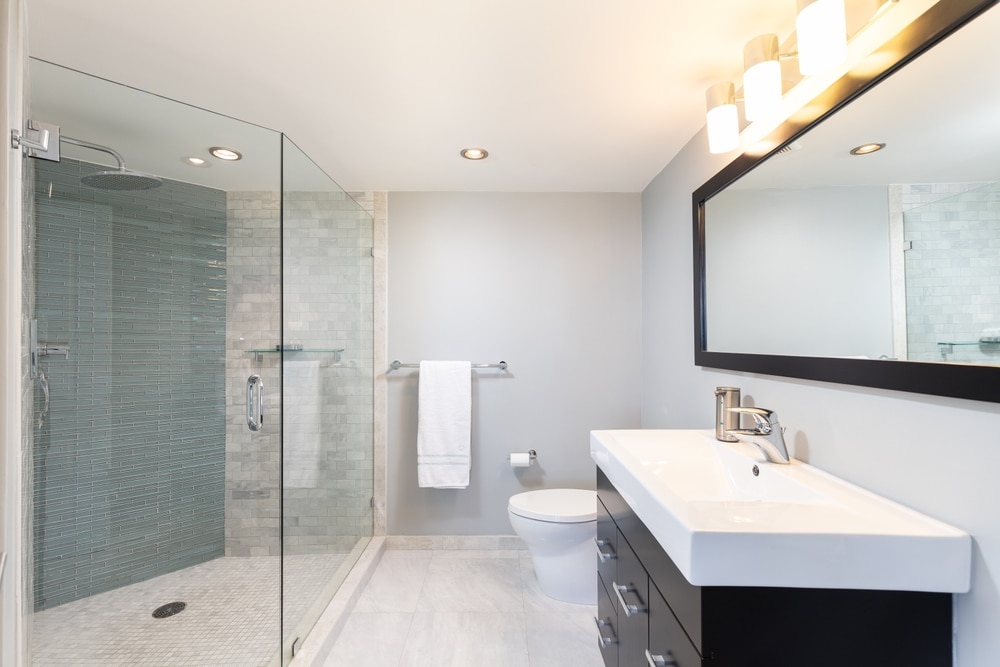 Bathroom with glass shower and black vanity