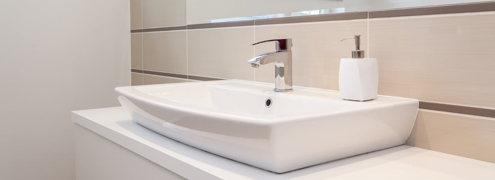 Silver bathroom tap detail in a bright remodel setting