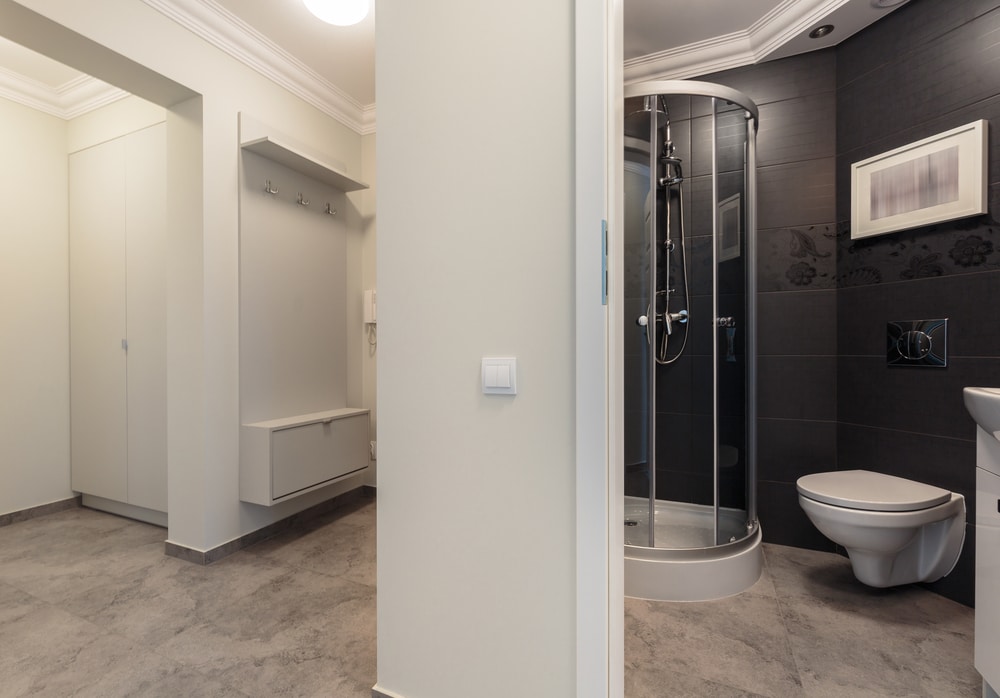 Compact gray bathroom with space-saving shower design