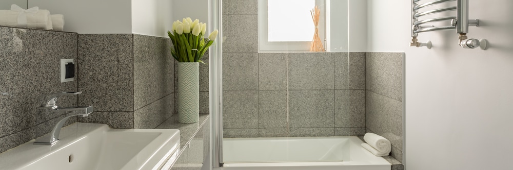 Small gray bathroom with a clean vanity and shower remodel layout