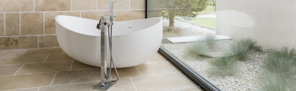 Modern bathtub and glass wall layout before a shower conversion