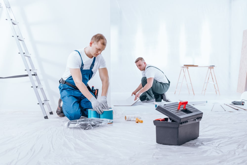 Remodeling crew preparing paints and tile materials