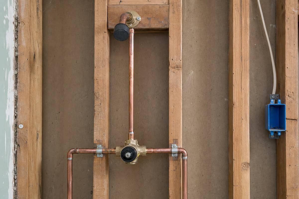 Shower valve and electrical box rough-ins secured to bathroom wall framing