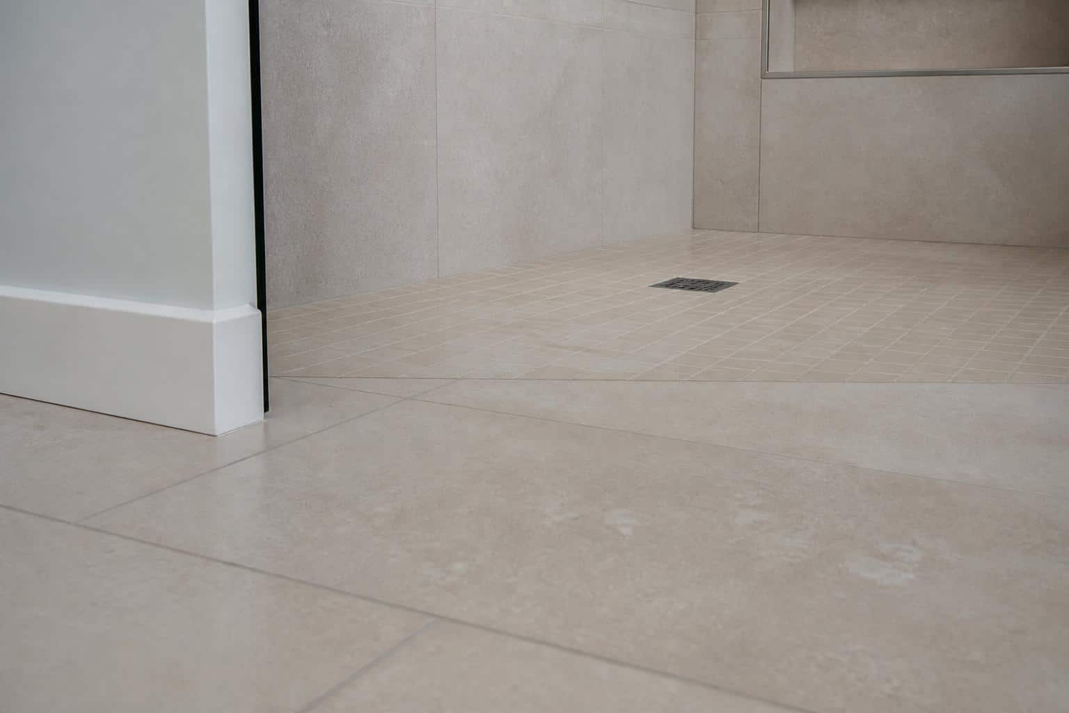 Traditional tiled shower with a low curb and framed glass door